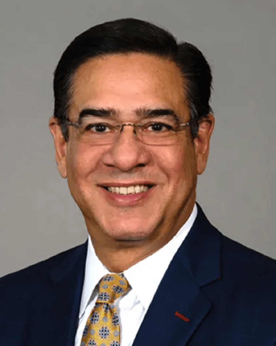 Smiling man wearing glasses and business attire